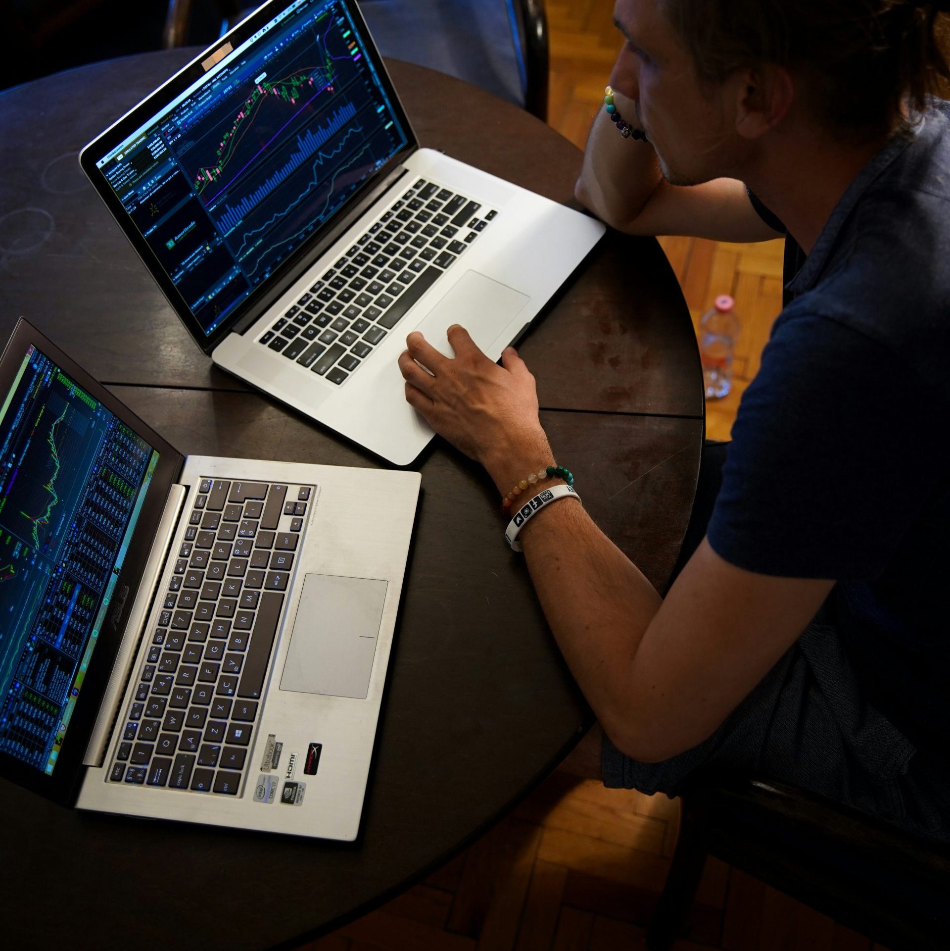 man sitting in front of the MacBook Pro